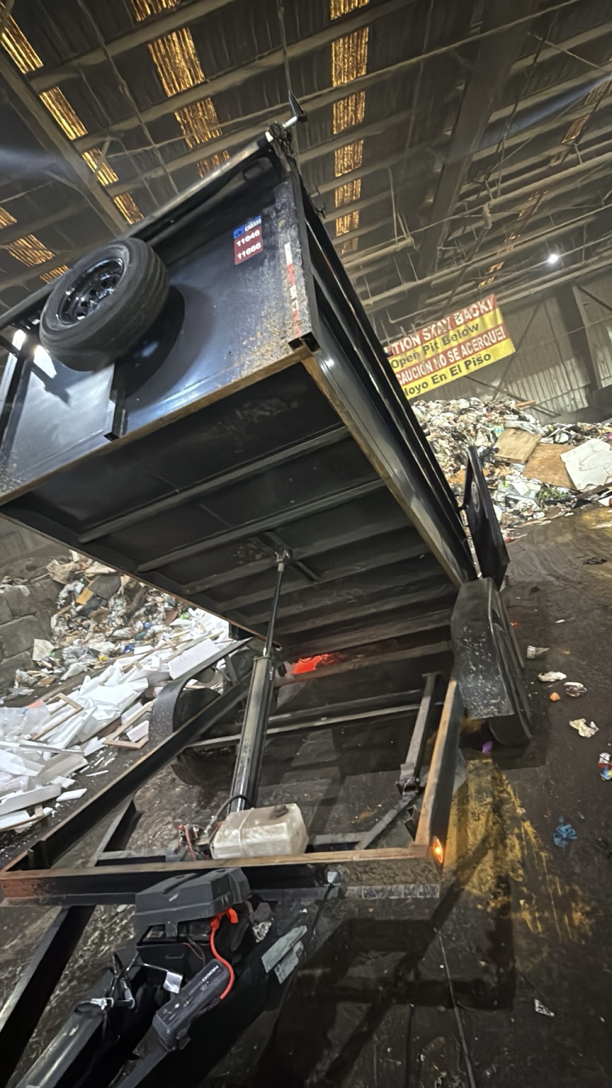 Dump trailer unloading hauled debris