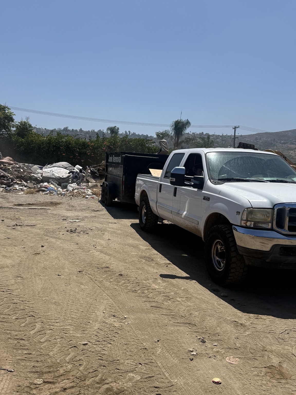 SD Pros truck and dump trailer at a disposal facility